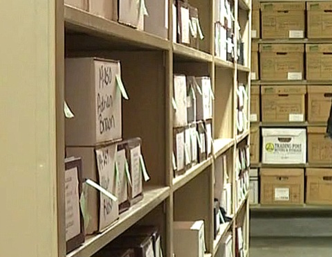 A room of shelves full of boxes containing unclaimed cremains