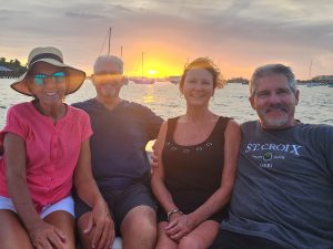 A group of adult friends enjoying a sunset boat tour