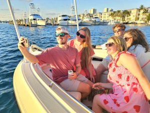 A group of friends enjoying a 2 hour narrated sunset cruise in Palm Beach near Sailfish Marina