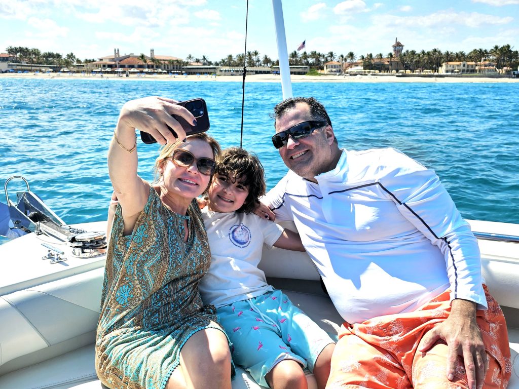 Mother, Father and young son posing for a selfie on the bow of a boat on the Intracoastal Waterway